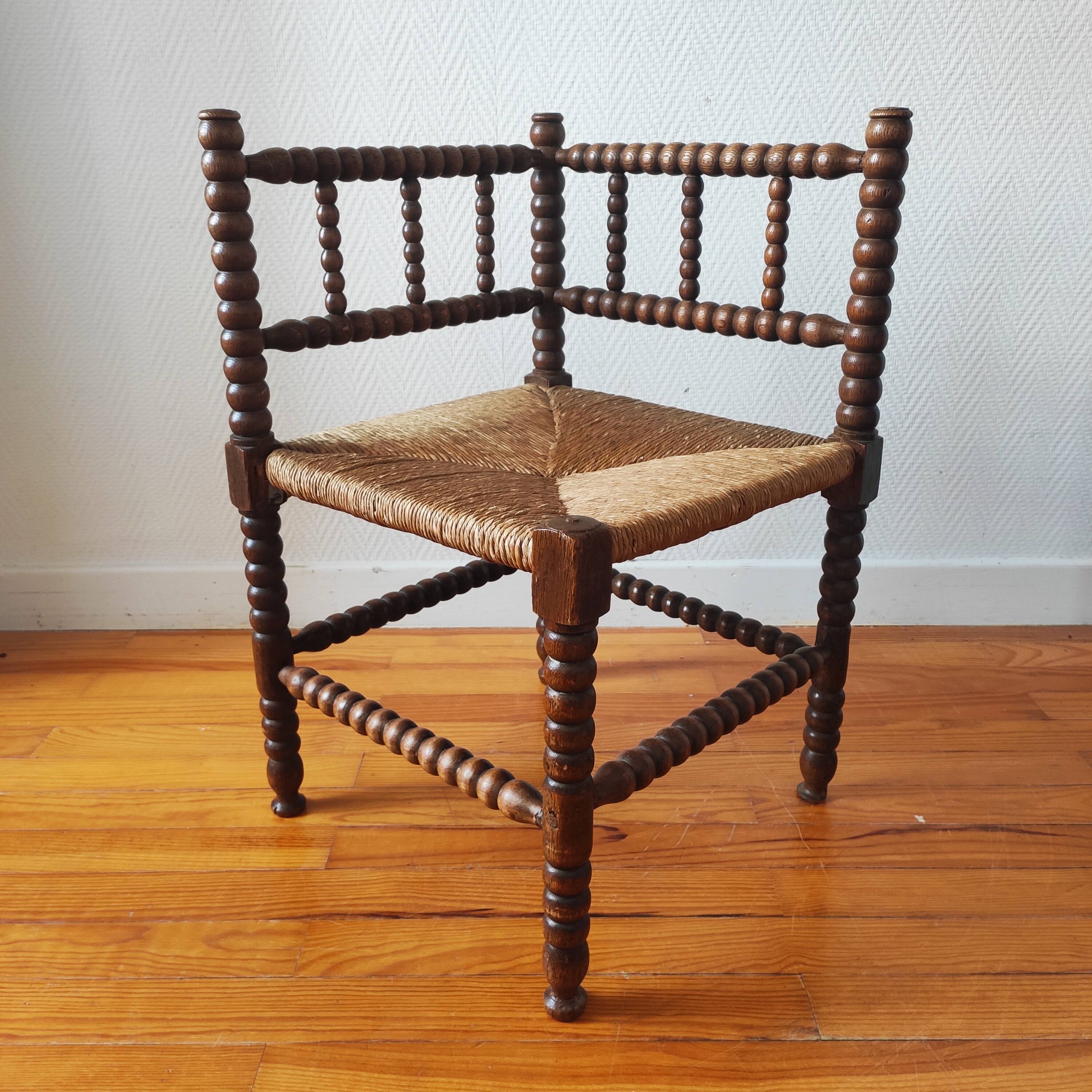 Antique corner chair made of turned wood spindle.