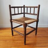 Antique corner chair made of turned wood spindle.