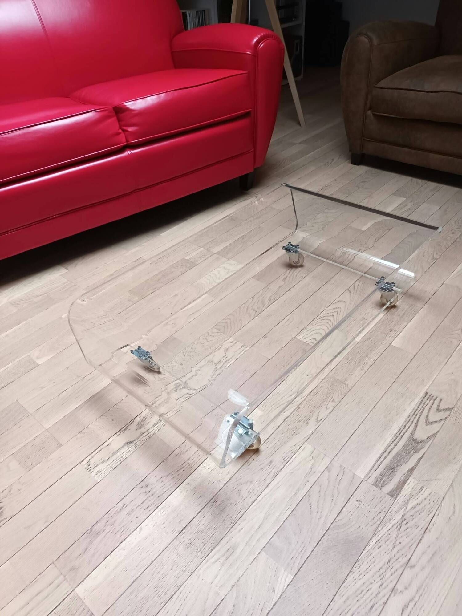Design coffee table from Habitat in transparent plexiglass, mounted on wheels.