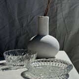 Circular glass ashtray with stylized petal patterns