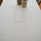 Old white tablecloth embroidered in linen