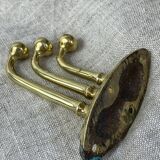 Coat hook with three-pronged folding hooks in brass