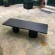 Rectangular coffee table in stained black wood with ball and cylindrical legs.