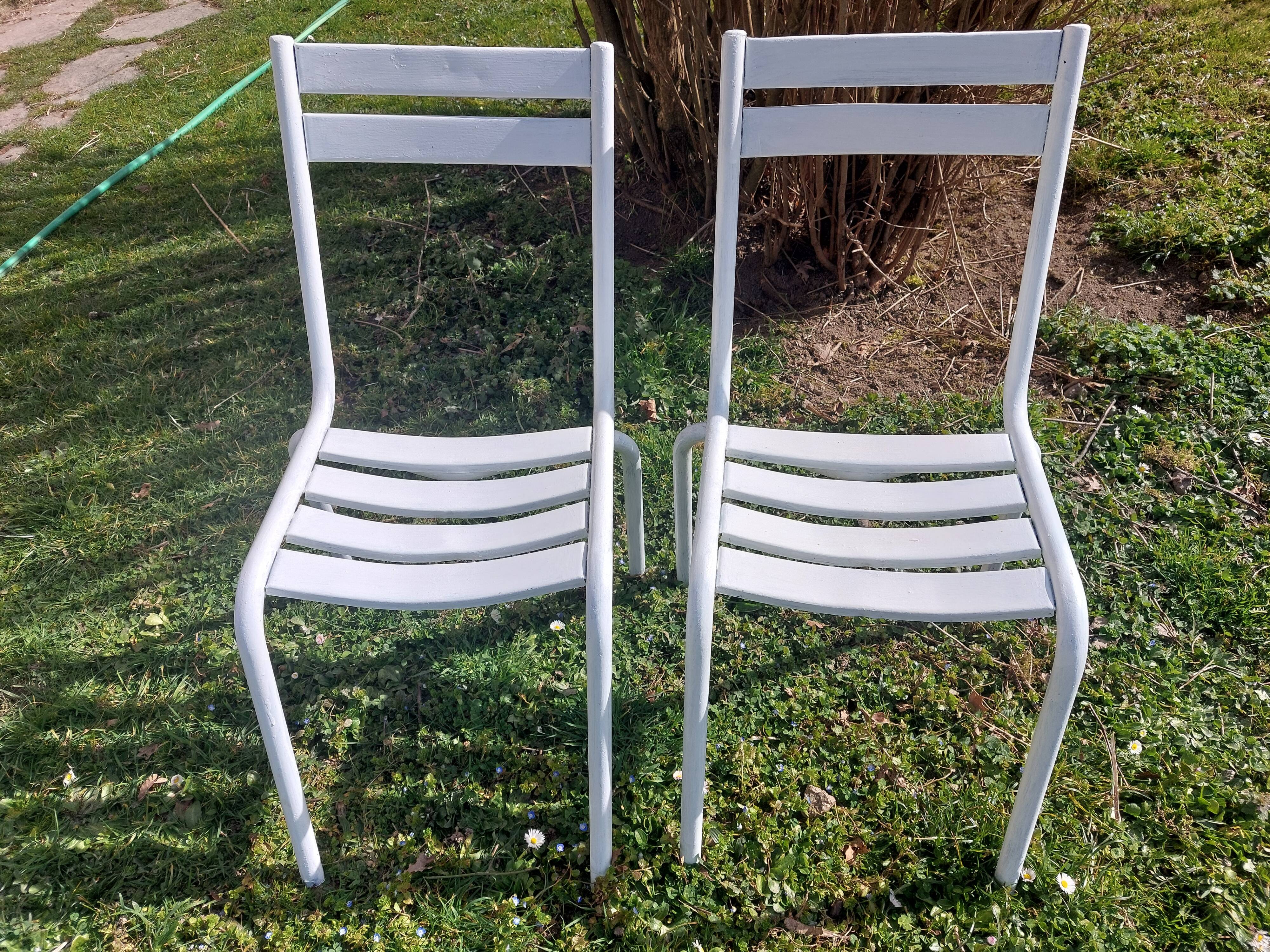 pair of white metal chairs, Tolix style