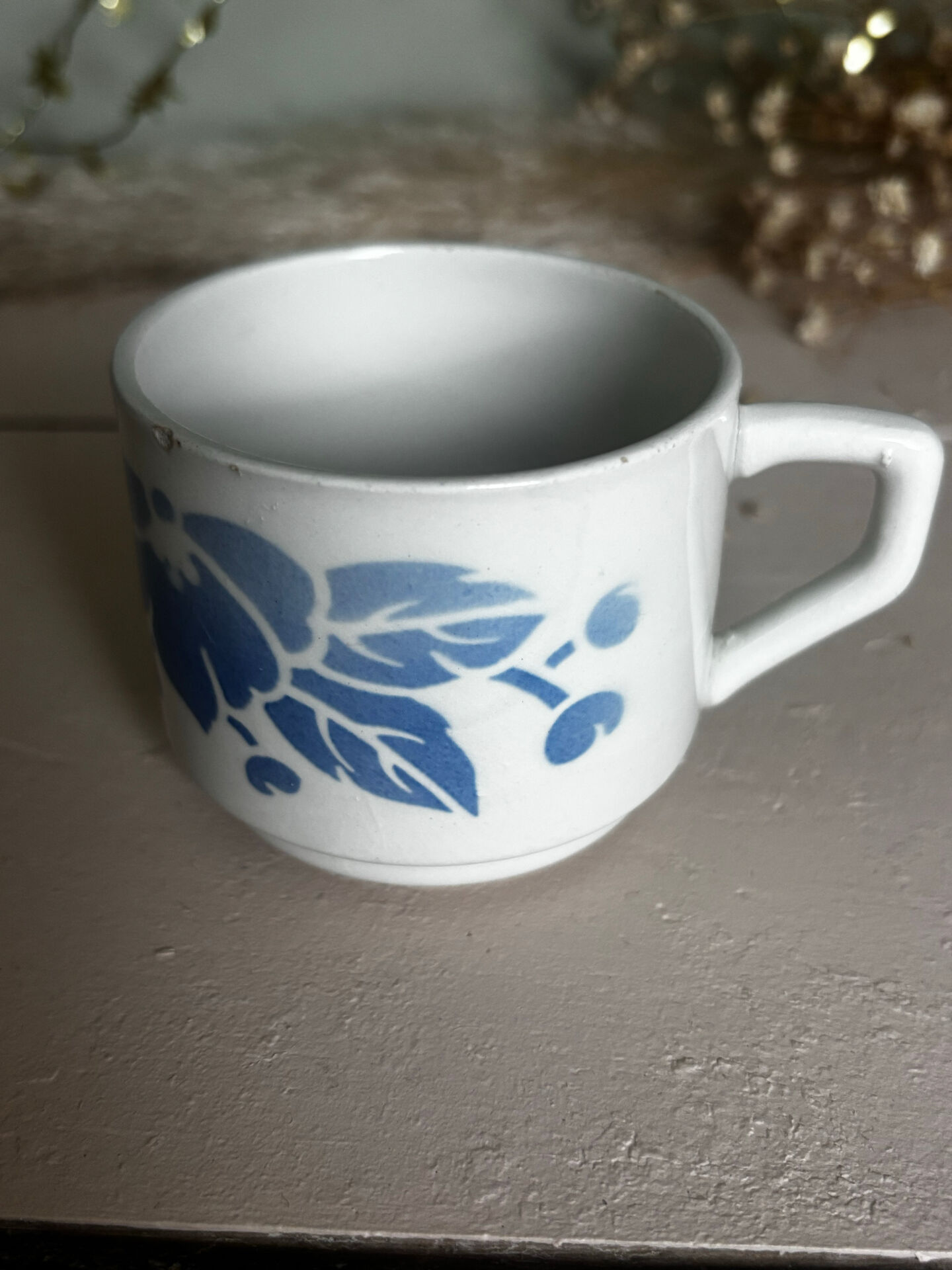 Set of 3 antique ceramic cups with blue floral pattern.