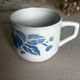 Set of 3 antique ceramic cups with blue floral pattern.