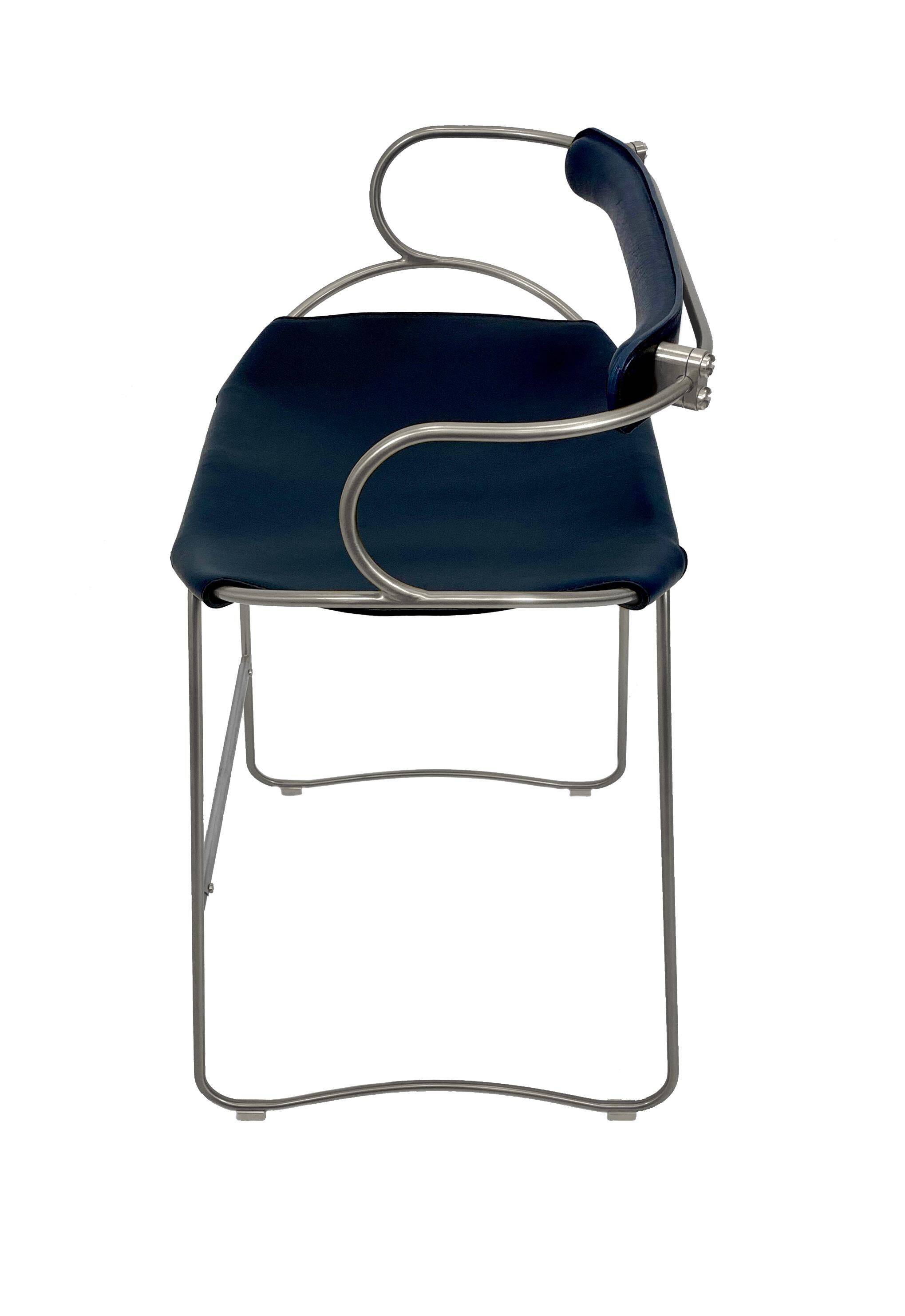 Kitchen bar stool with a weathered silver metal backrest and navy blue leather.