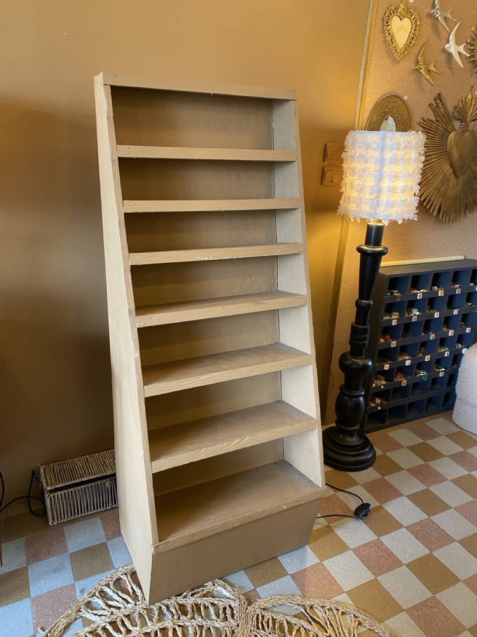 Painted wooden display shelf with an incline