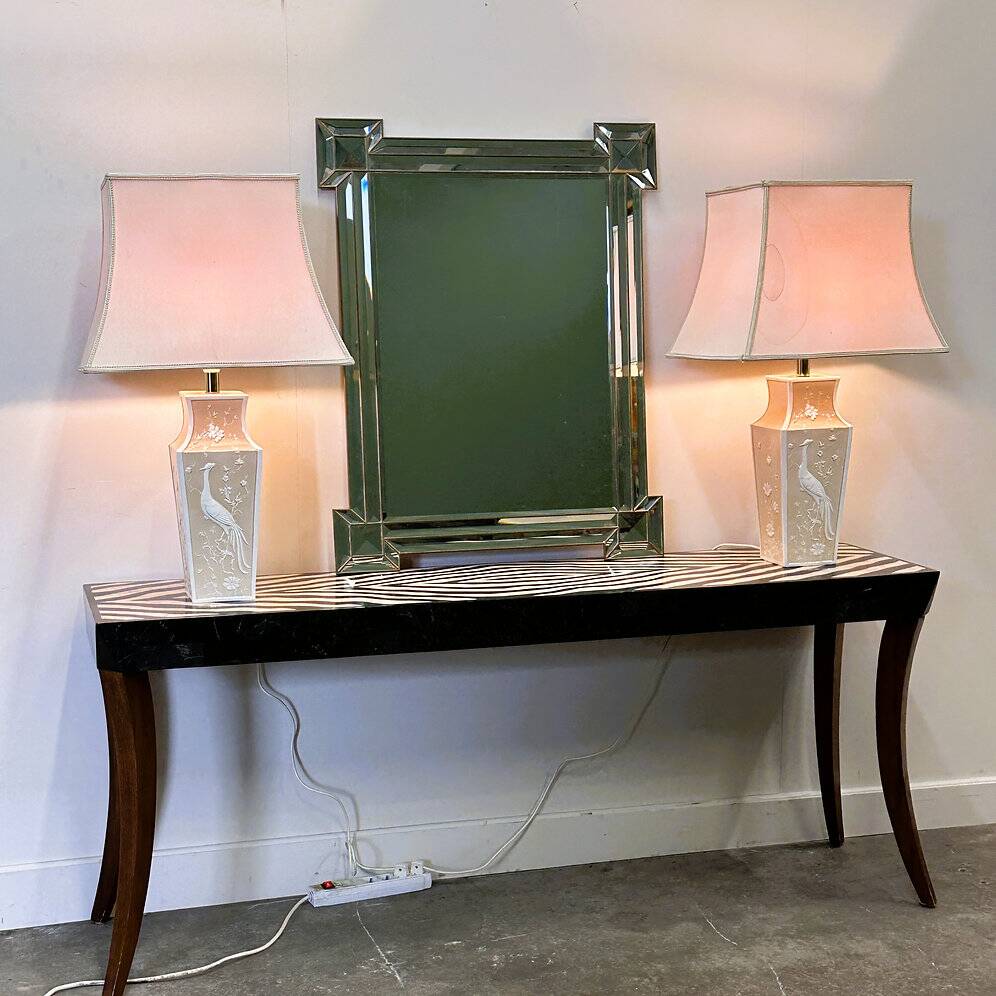 Pair of large cream ceramic table lamps with relief peacocks and fabric shades