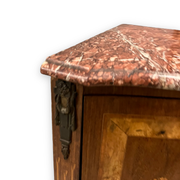 Louis XVI style corner buffet with marquetry decoration featuring a vase of flowers