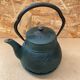 Old green cast iron Japanese teapot with flower decoration + vintage stand