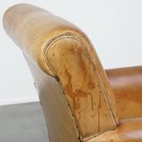 Stylish patinated vintage sheepskin armchair with a comfortable seat