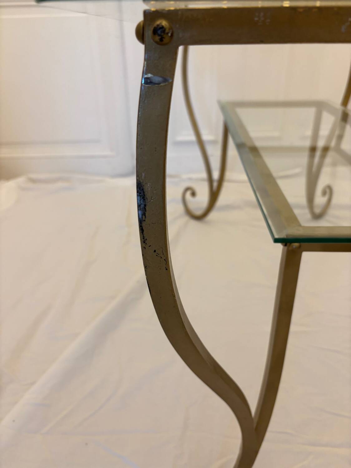 Large gold wrought iron and glass side table.