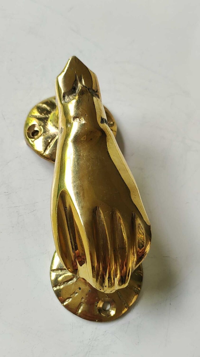 Hand-shaped door knocker. In polished brass, beautiful shine