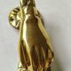 Hand-shaped door knocker. In polished brass, beautiful shine
