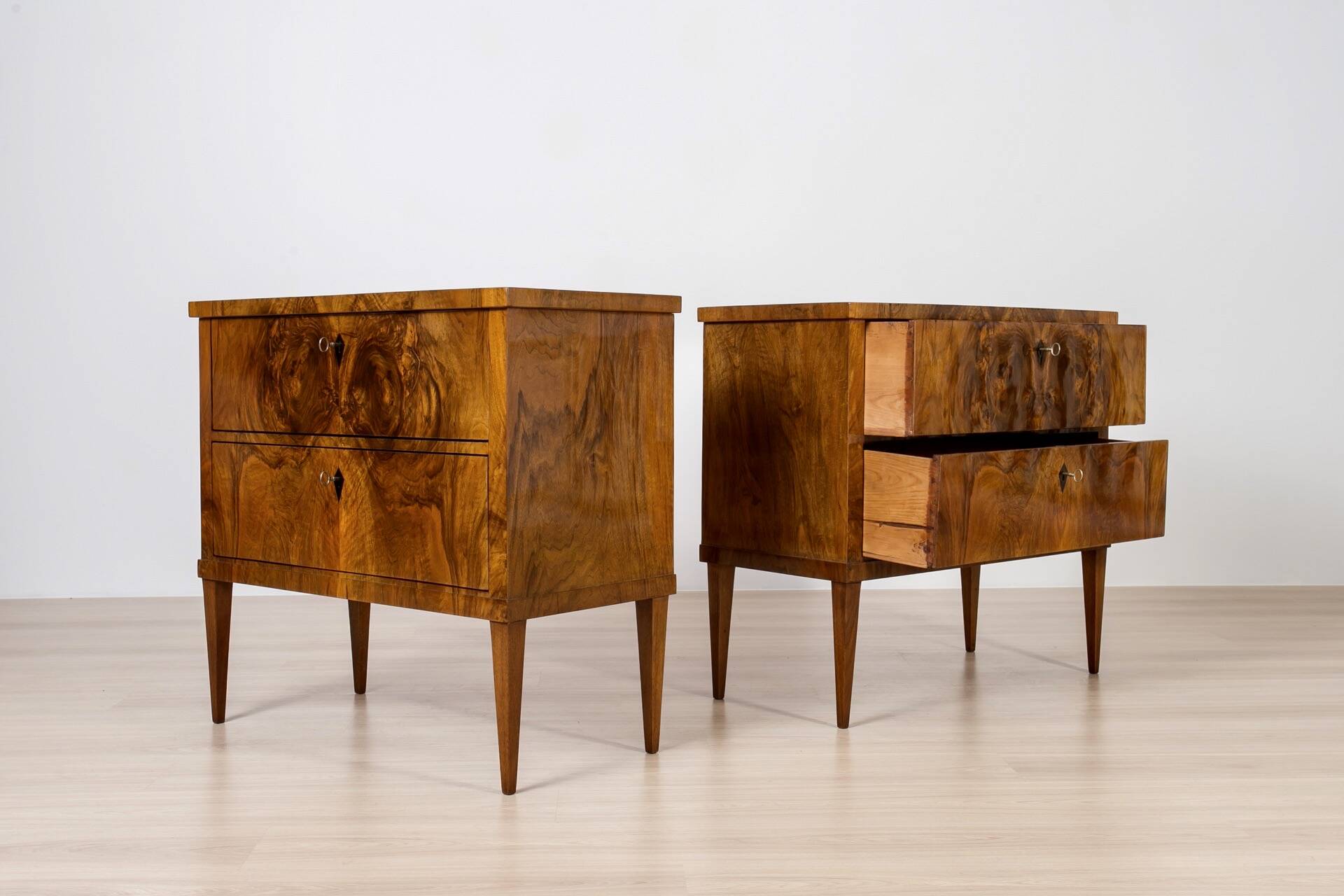 Elegant pair of Biedermeier style walnut commodes, Germany, French polish.