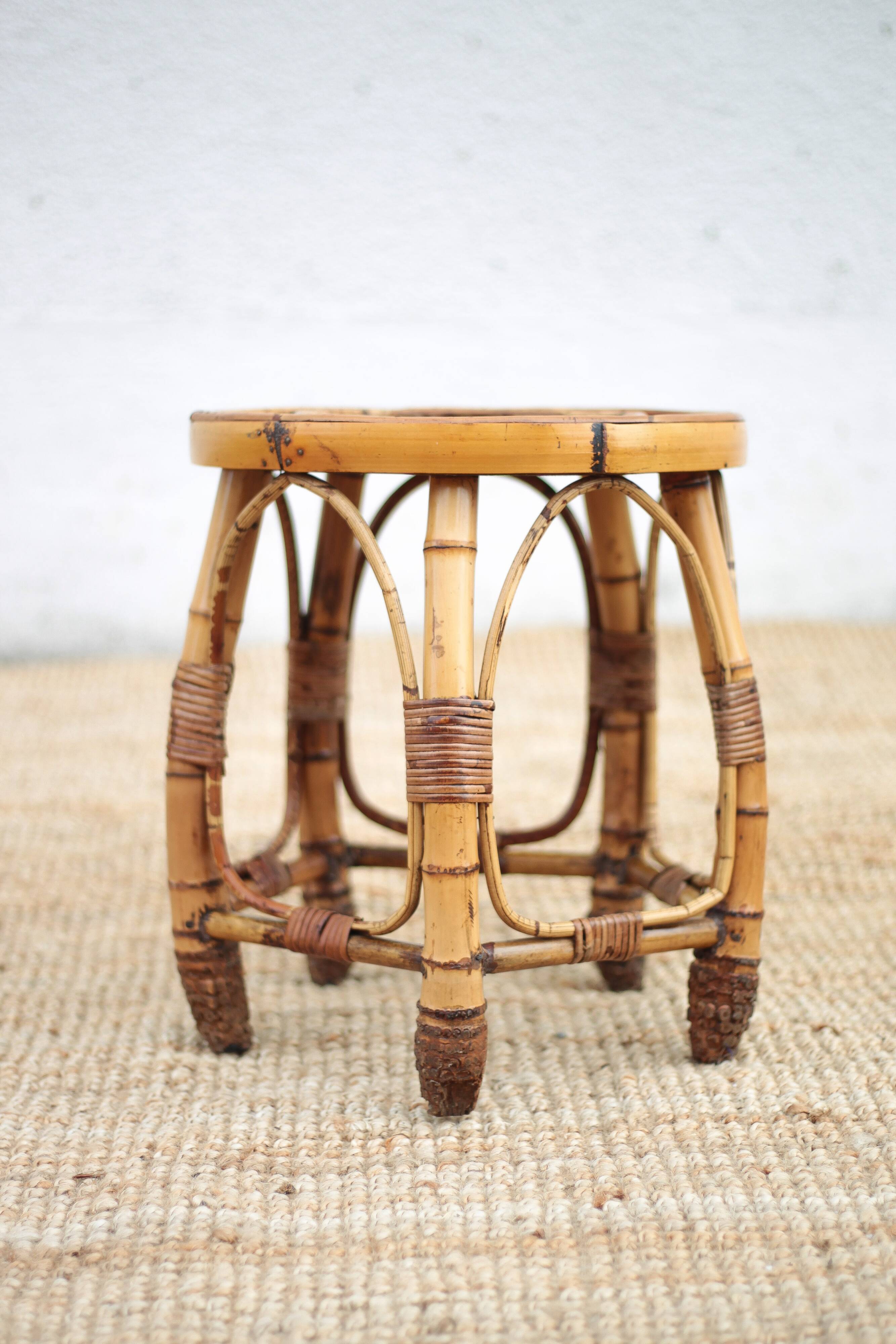 Vintage bamboo stool, woven rattan plant stand, interior decoration.