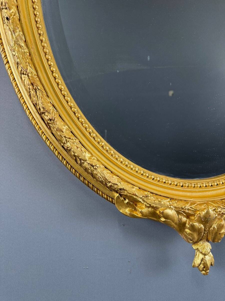 Miroir ovale doré style Louis XVI, XIXe siècle
