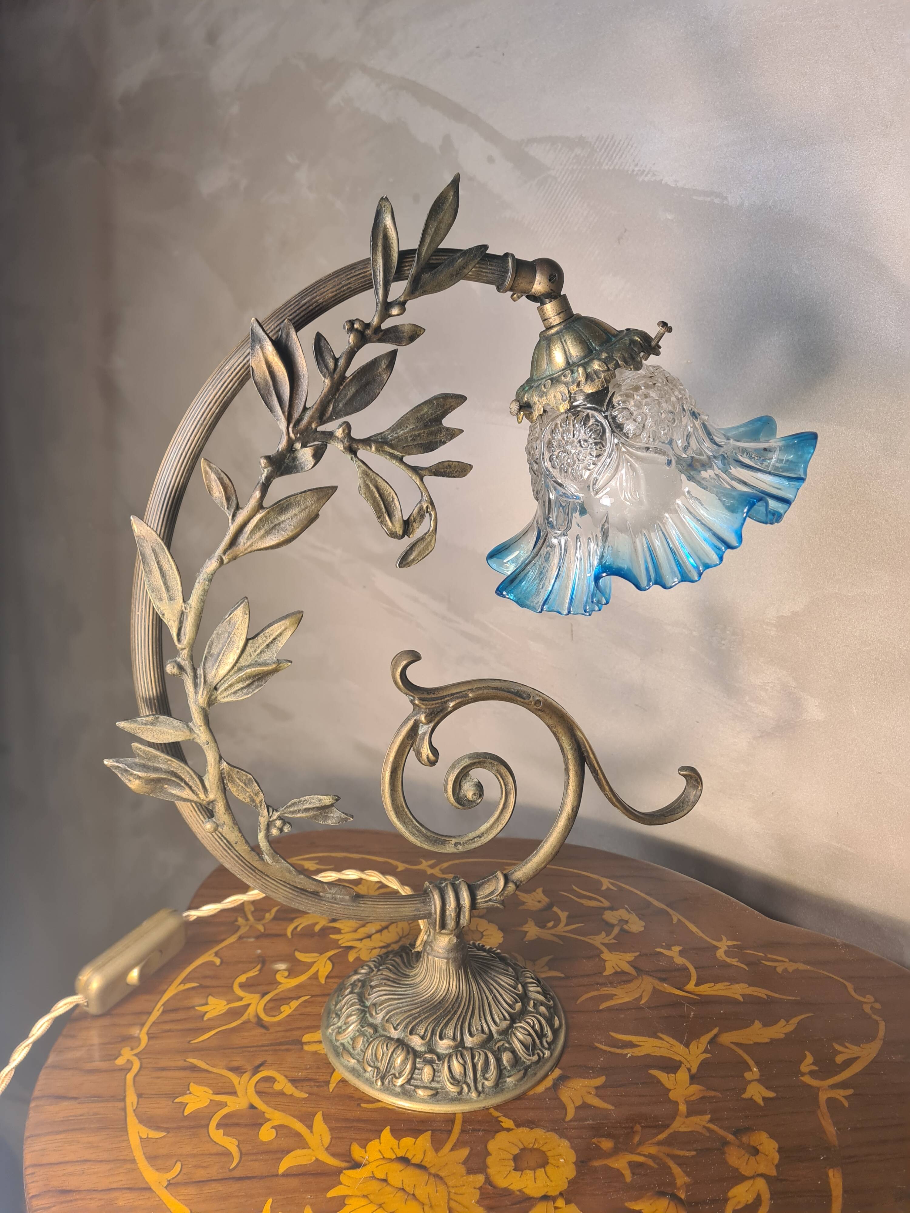 Bronze and brass lamp, transparent and blue glass shade.