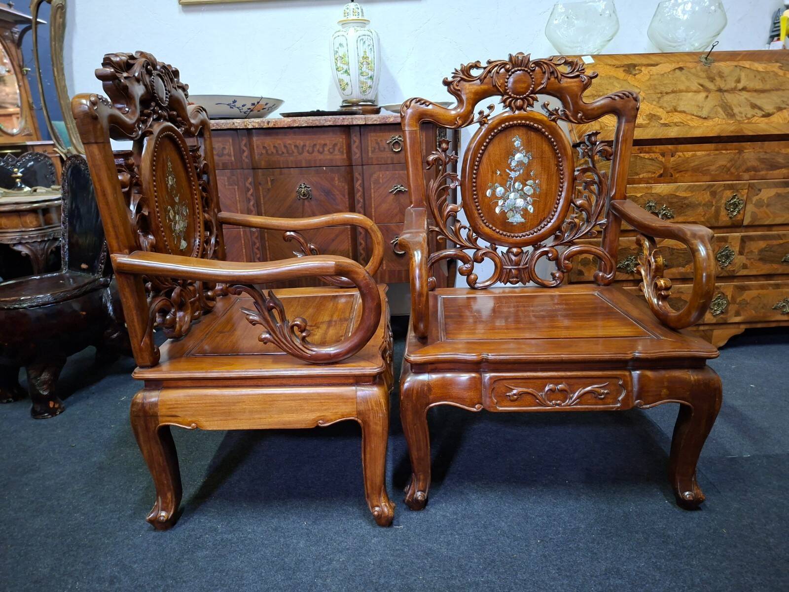 Pair of Asian armchairs in carved wood with mother-of-pearl inlays.