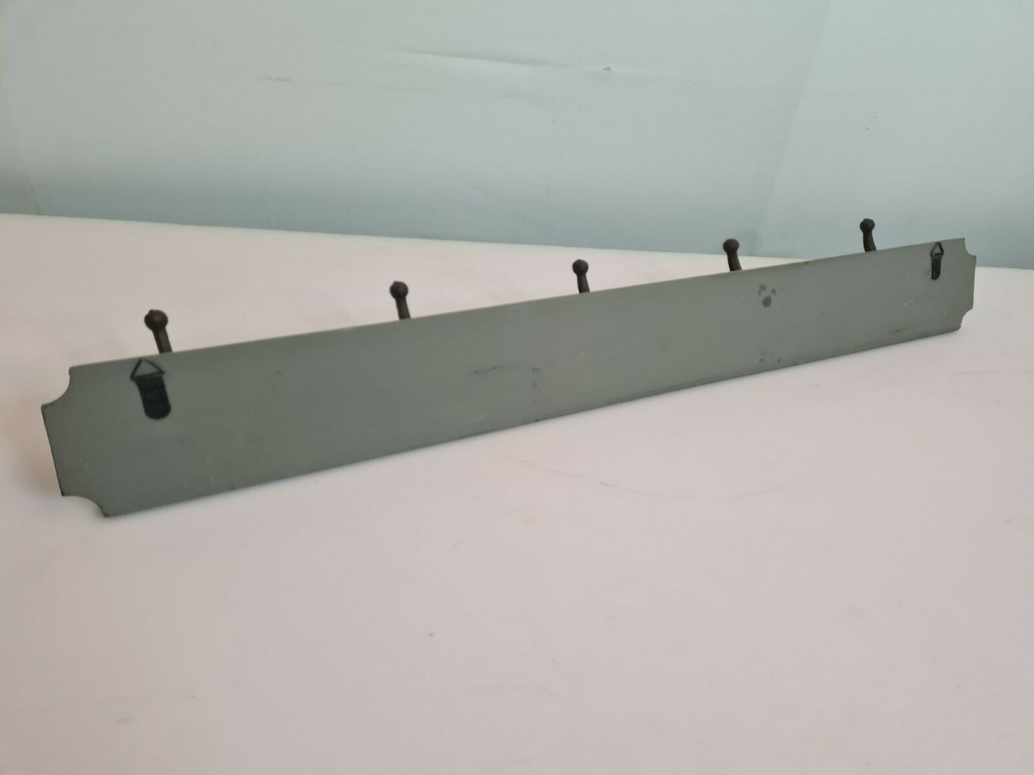 Wooden coat rack with cast iron hooks