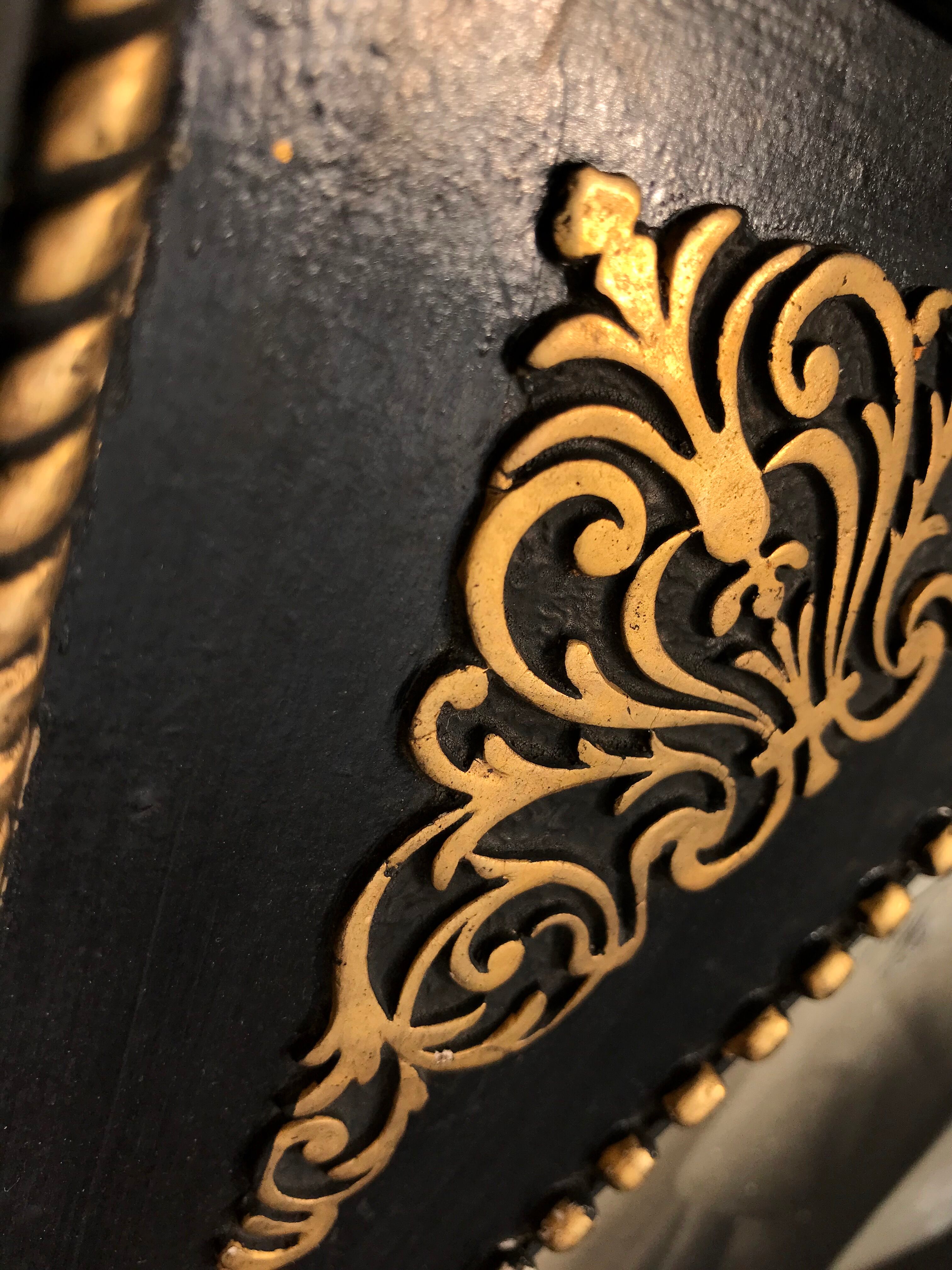 Black and gilded ebonite frame, wood and plaster 19th century