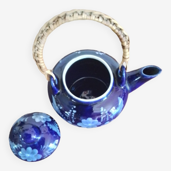 Small blue teapot and its wicker handle