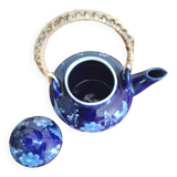 Small blue teapot and its wicker handle