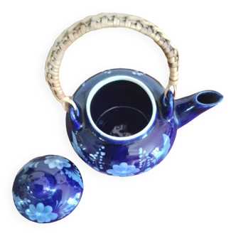 Small blue teapot and its wicker handle