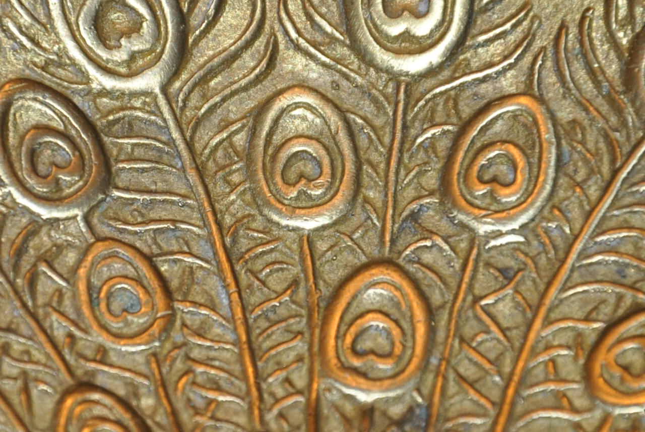 Brass pocket with peacock decoration