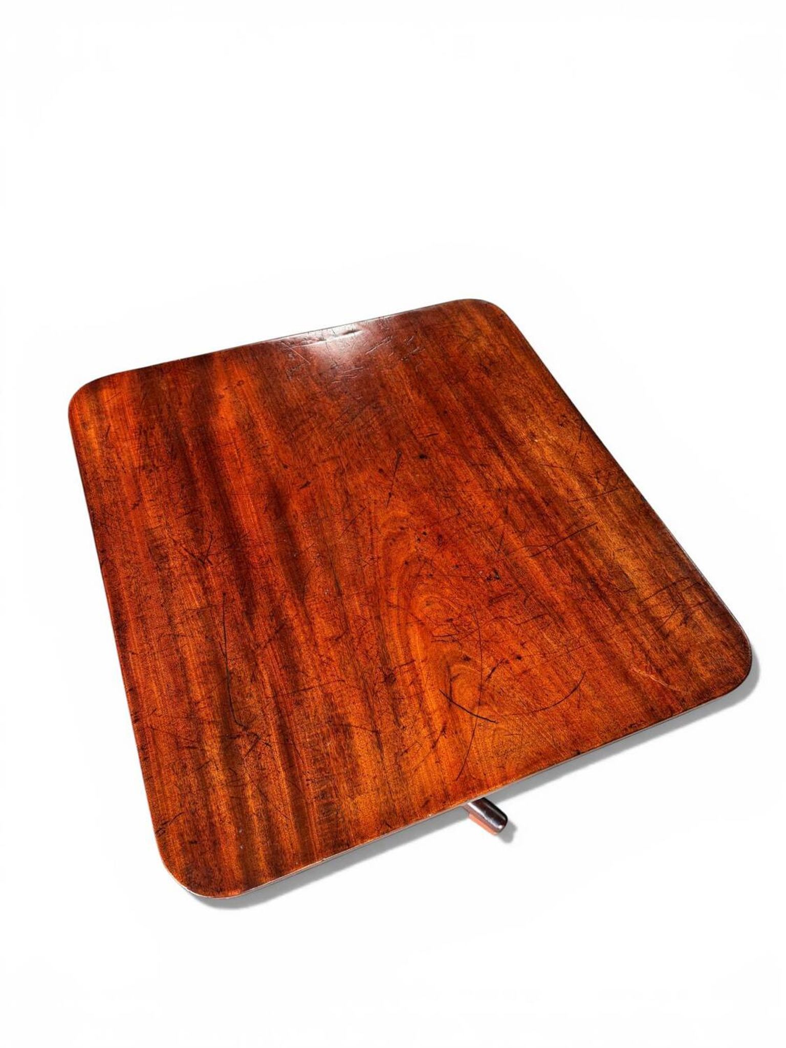 19th-century solid mahogany table with a tilting top and brass mechanism.