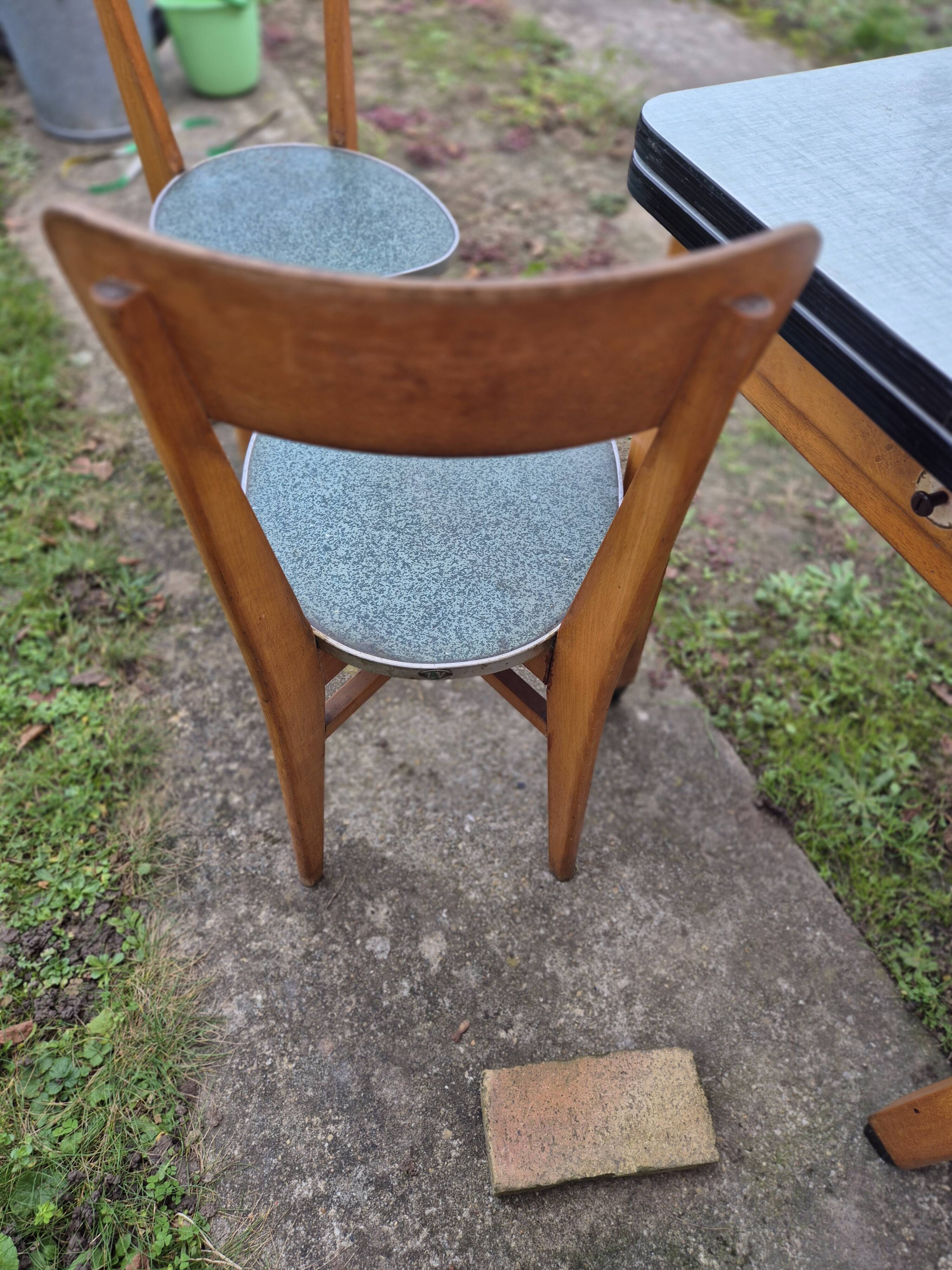 Vintage Scandinavian table and chair set with a wooden frame and formica top.