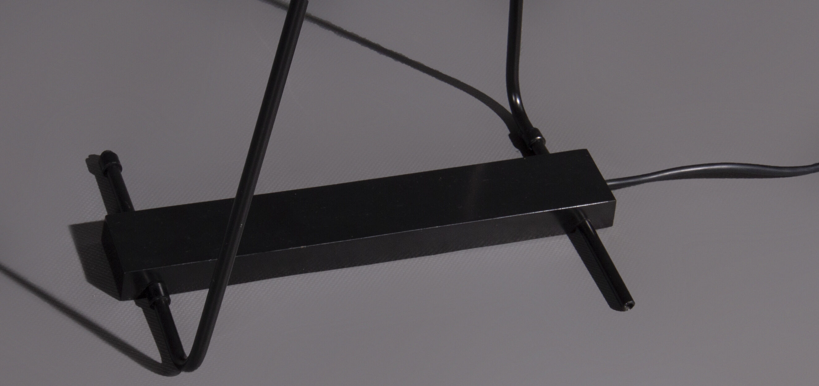 Floor lamp made from black painted metal with balancing arm