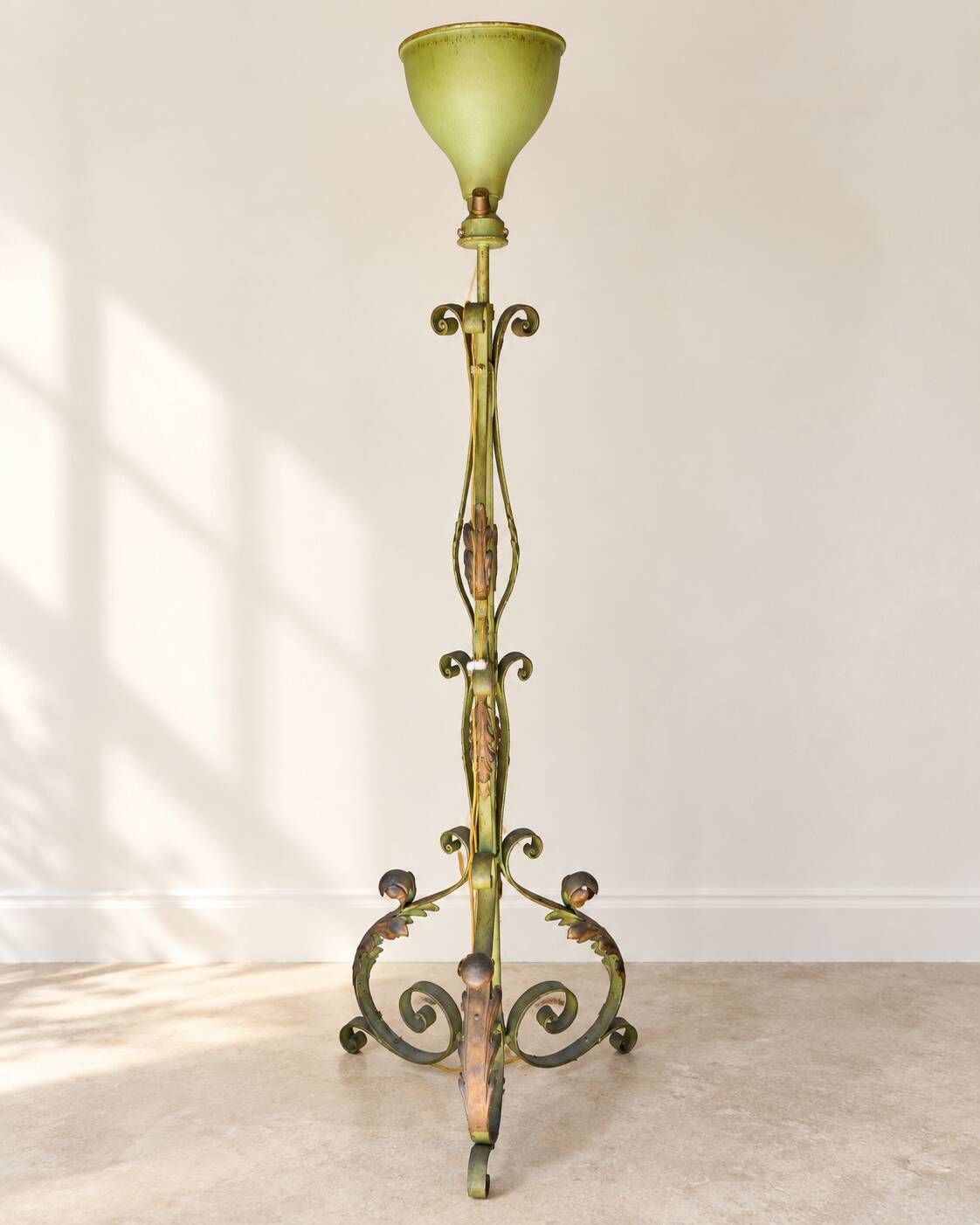 Antique green-painted iron floor lamp with a floral design.