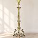 Antique green-painted iron floor lamp with a floral design.