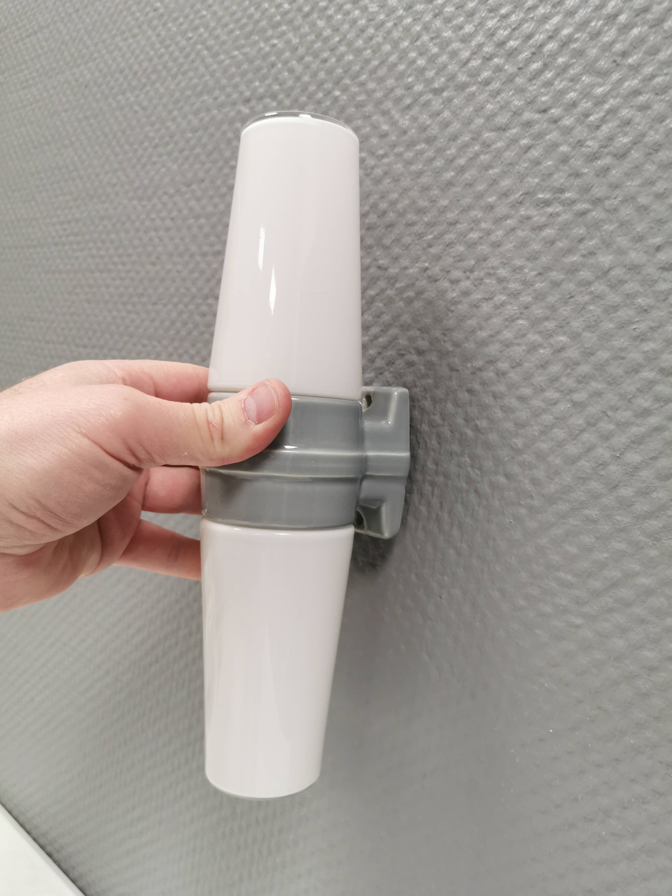 Bathroom lamp with light gray ceramic base,  and milky white opal glass.