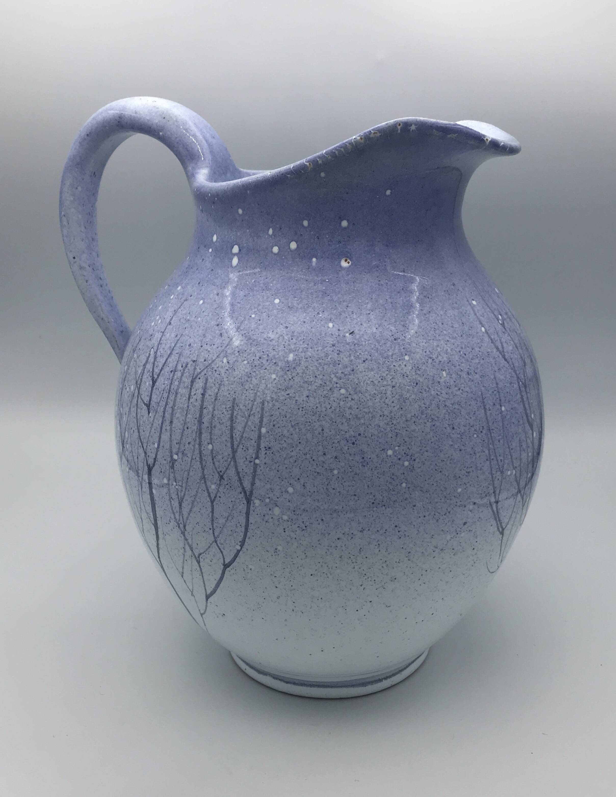 Blue glazed terracotta pitcher with hand-painted decoration, signed