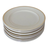 Set of 11 flat white earthenware plates with gold edging