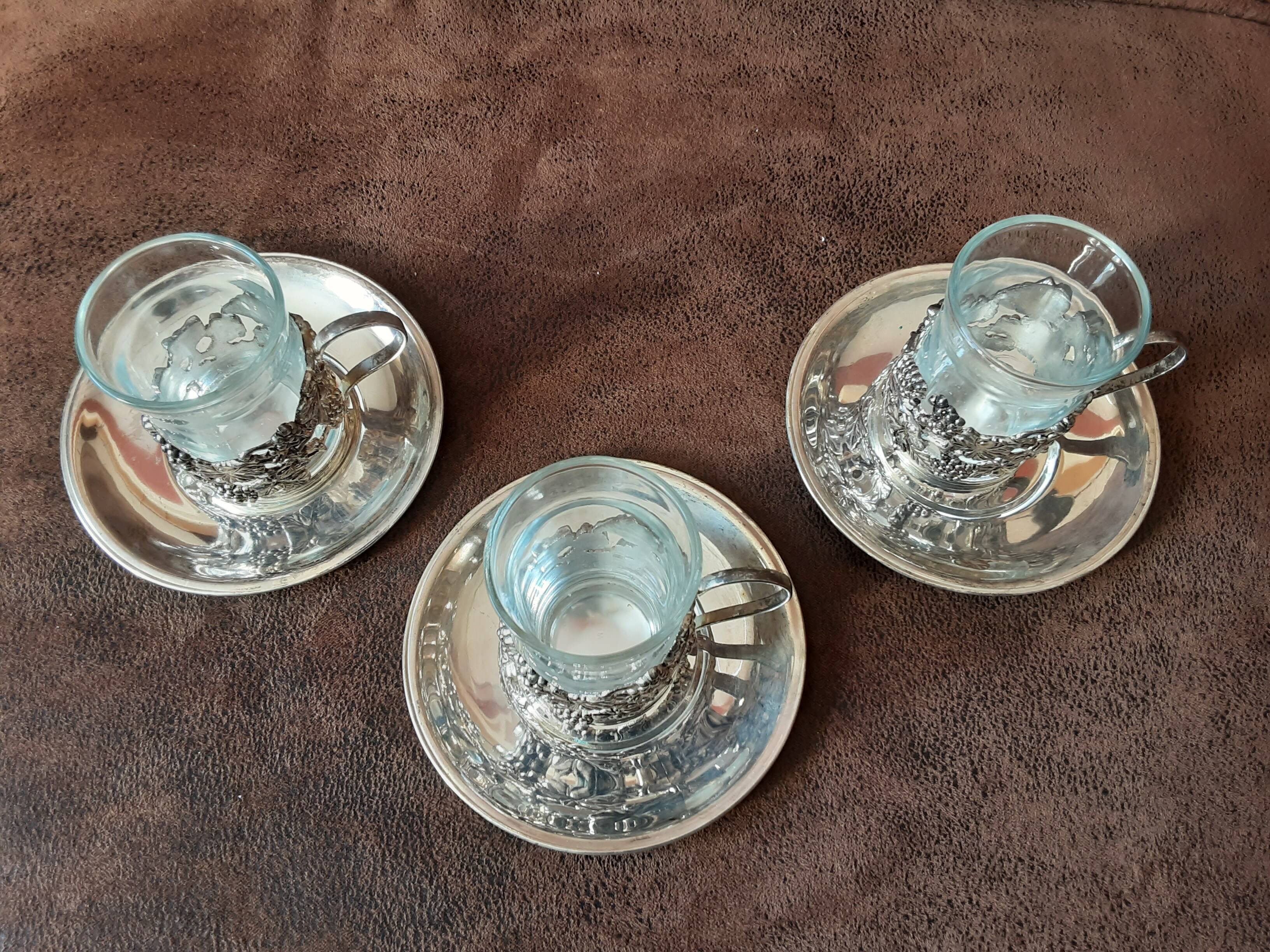 Set of 3 small metal glasses and saucers