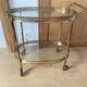 Oval golden brass rolling dessert trolley, Maison Jansen style, 1960s.