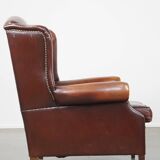 Dark English style sheepskin wingback chair with character and patina