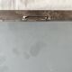 Vintage wall mirror in varnished steel decorated with a rose in relief