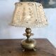 Antique brass lamp with embroidered openwork shade.