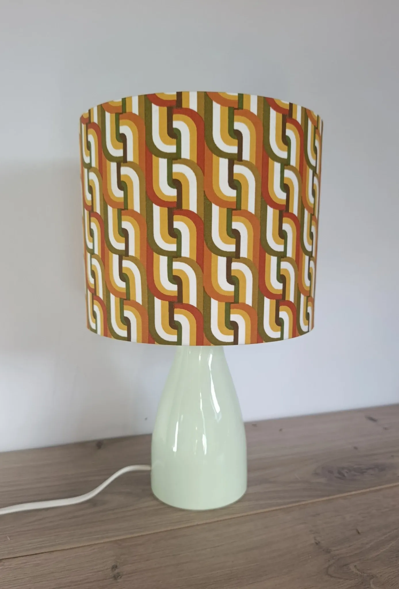 Seventies spirit lamp with geometric orange/green lampshade.
