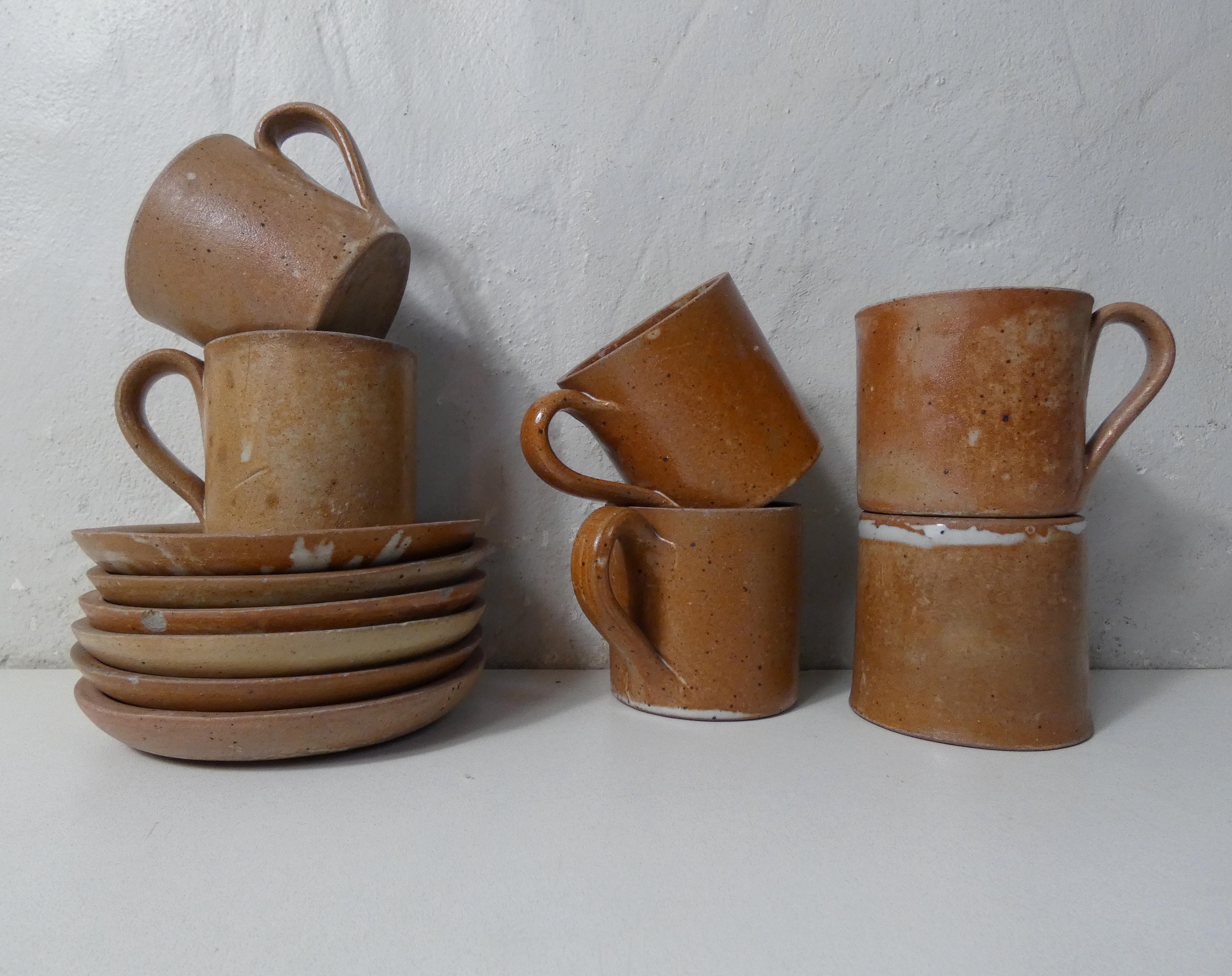 6 stoneware cups and saucers