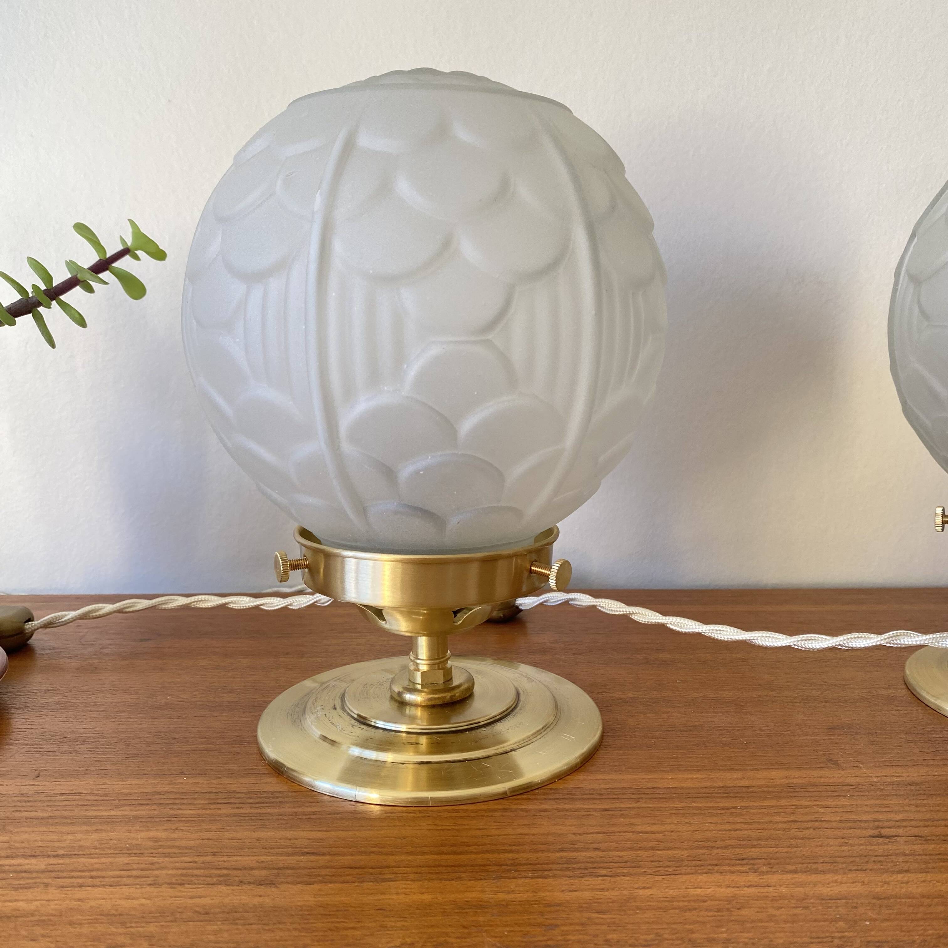 Pair of Art Deco glass globe table lamps with brass base.