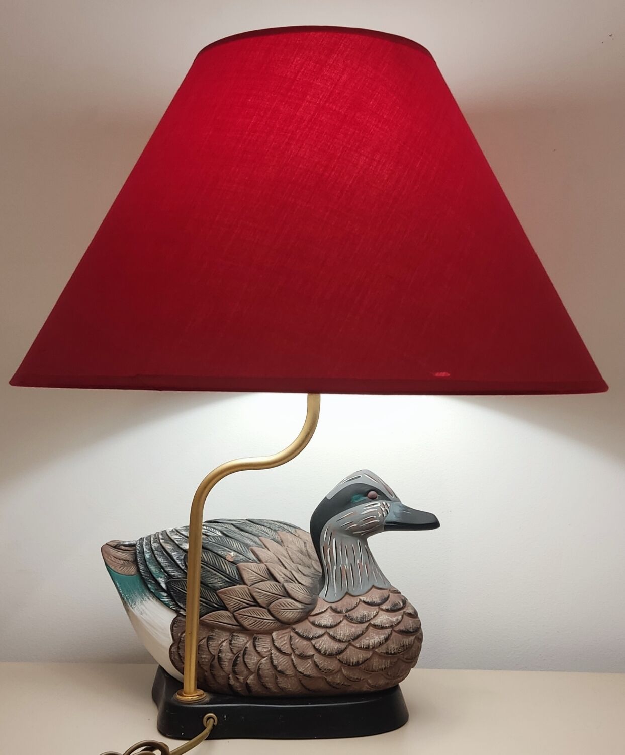 Decorative table lamp with a sculpted duck-shaped base and painted finish.