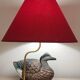 Decorative table lamp with a sculpted duck-shaped base and painted finish.