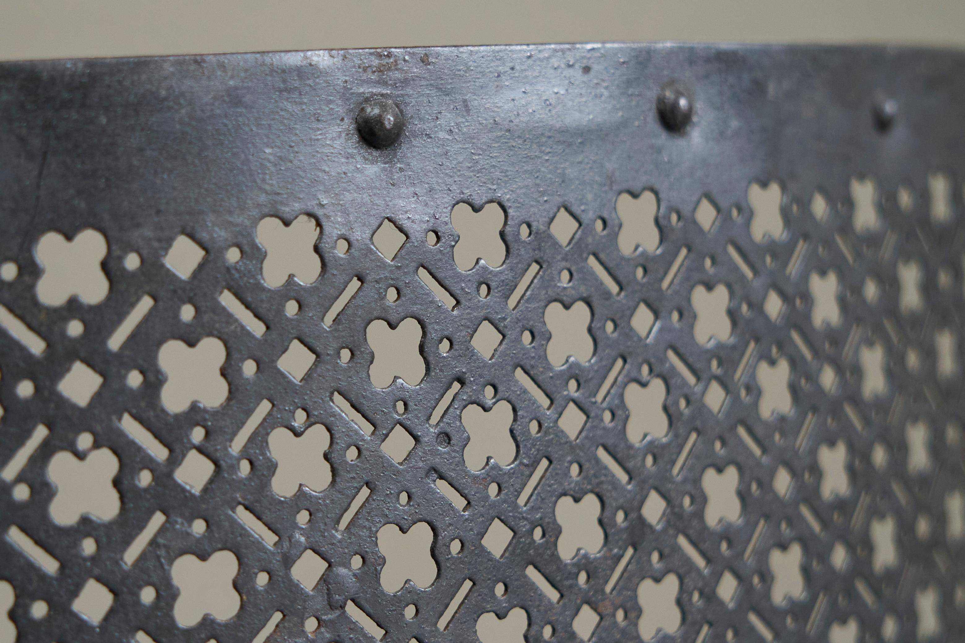 Half-moon antique wrought iron fire screen from the 19th century.