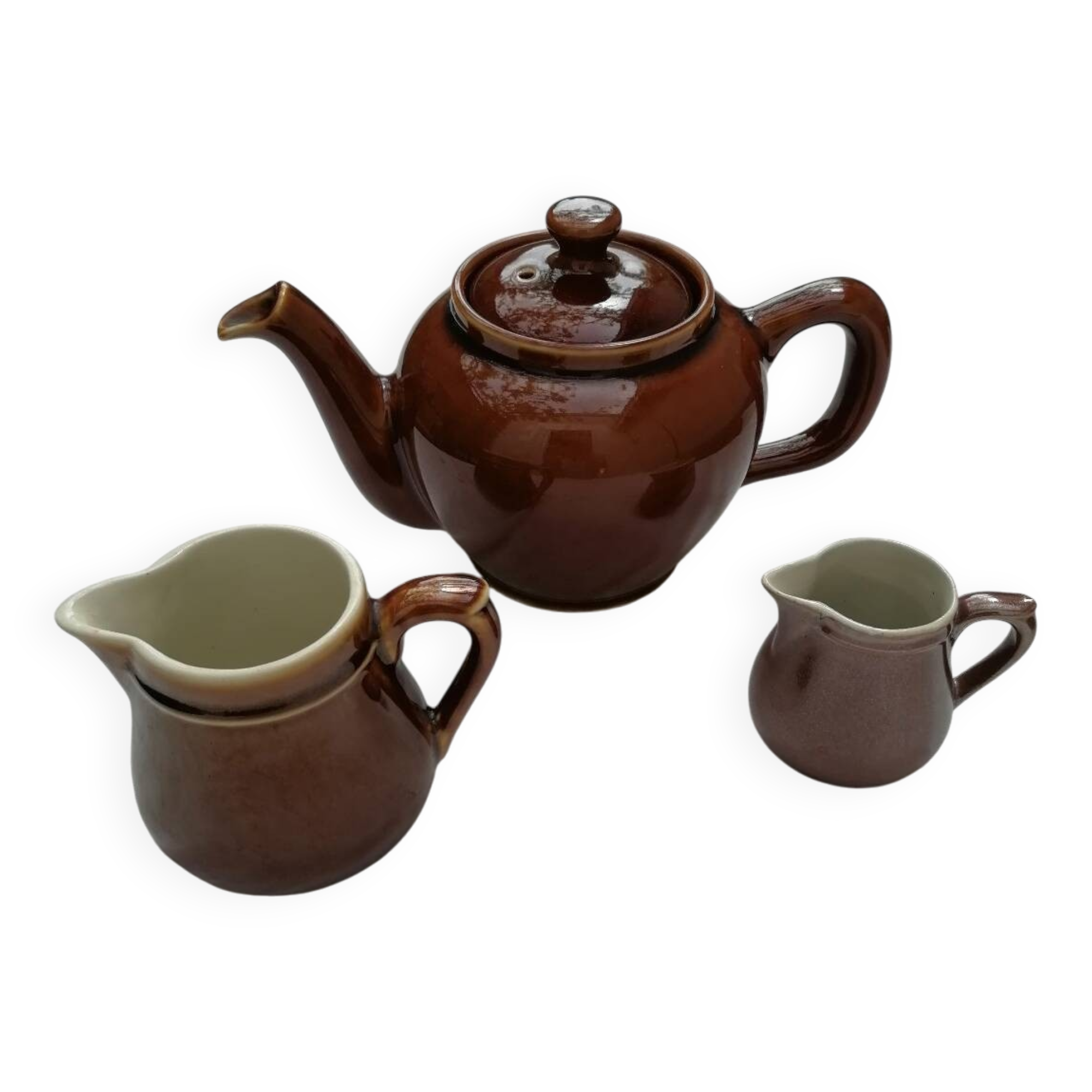 Brown ceramic teapot and milk jugs